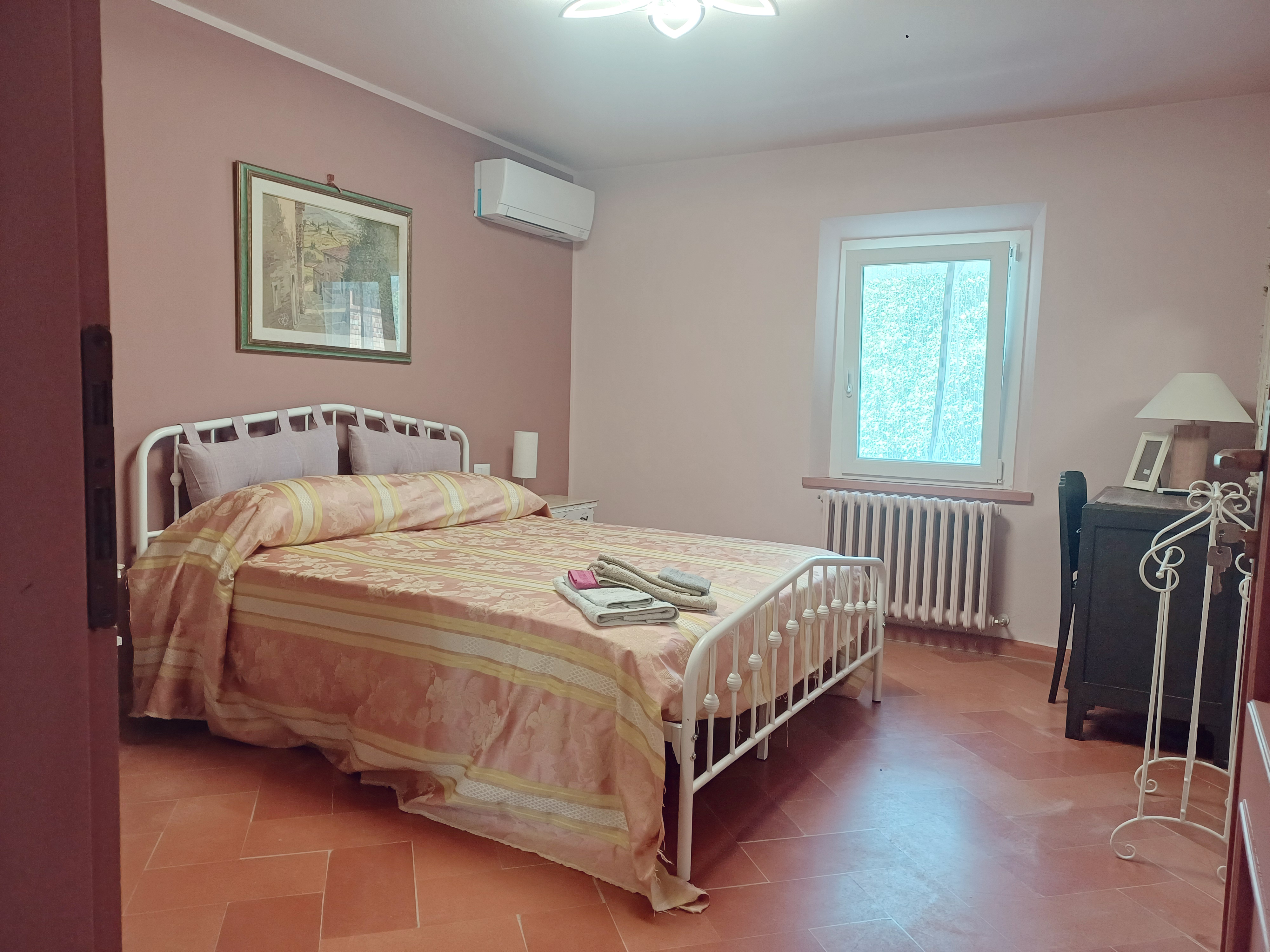 Iris Room at Genevieve Grove, a bright and comfortable guest room in the Tuscan countryside.