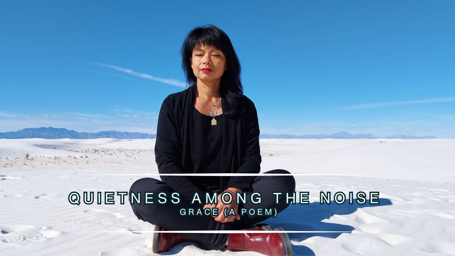 Genevieve Cheung meditating in white sand dunes under a clear blue sky, with the words “Quietness Among the Noise – Grace (A Poem)” displayed across the image.
