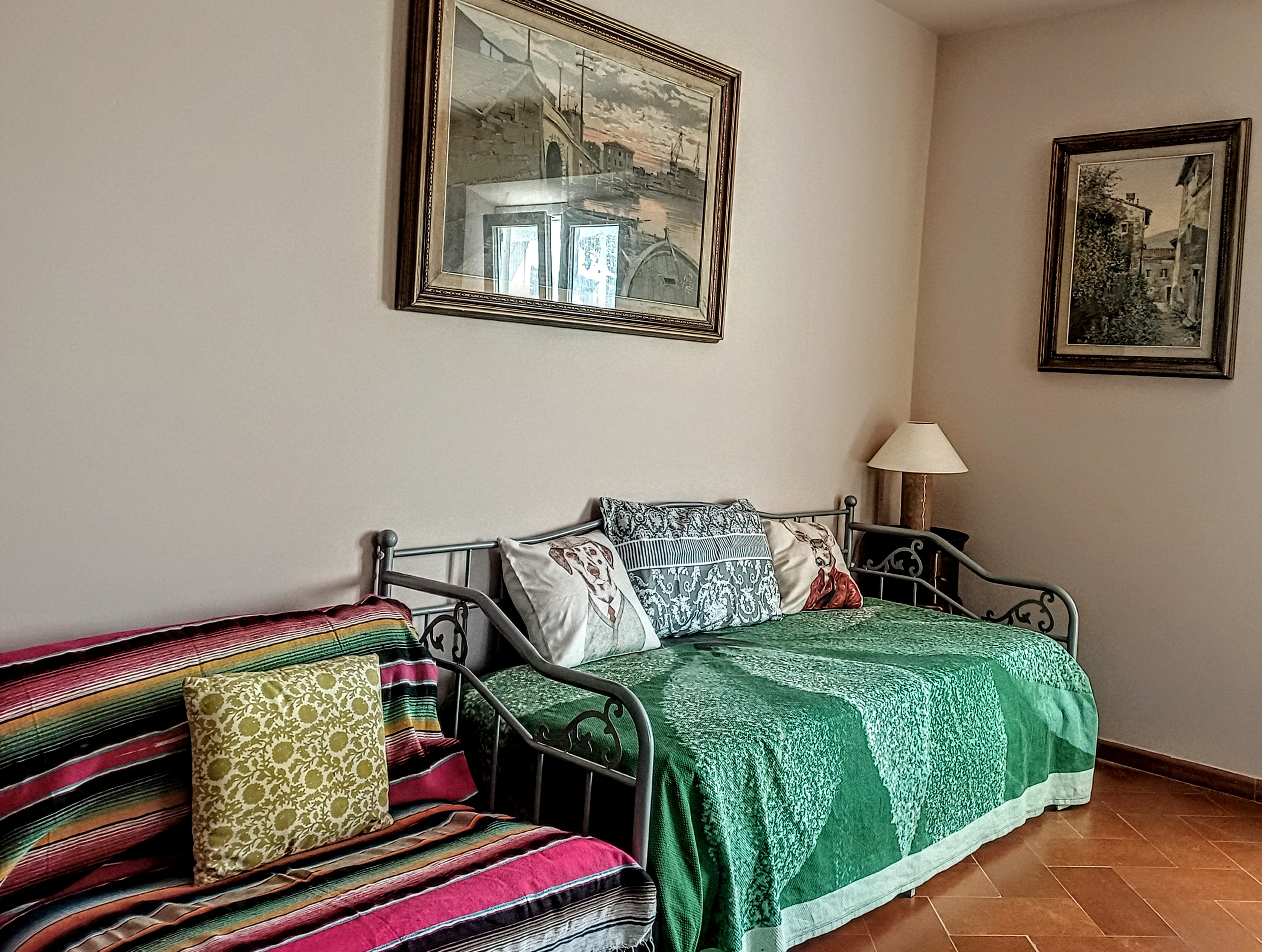 Decorative daybed and seating area in La Rosa Room at Genevieve Grove
