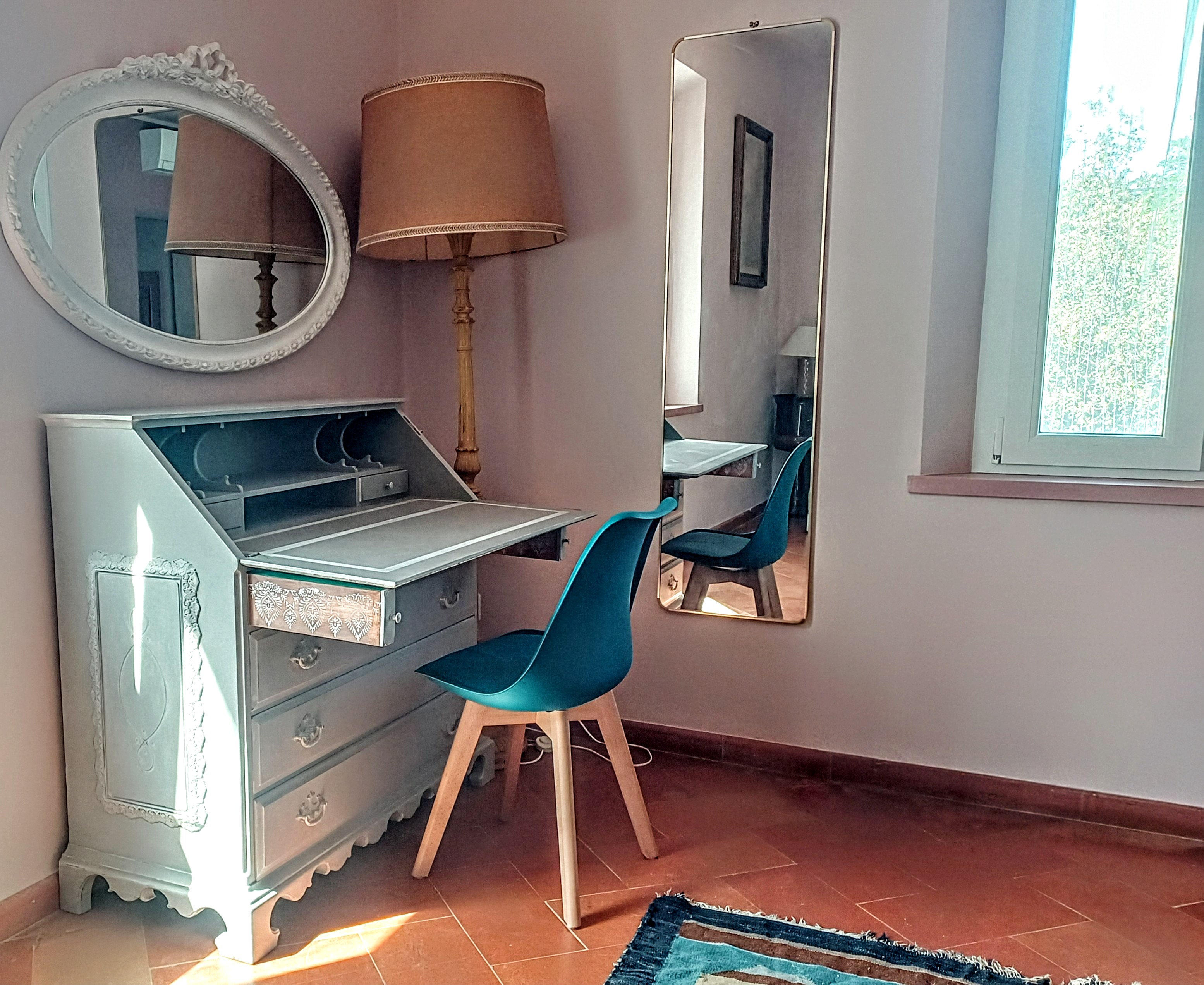 Writing desk, chair, and decorative mirror in La Rosa Room at Genevieve Grove