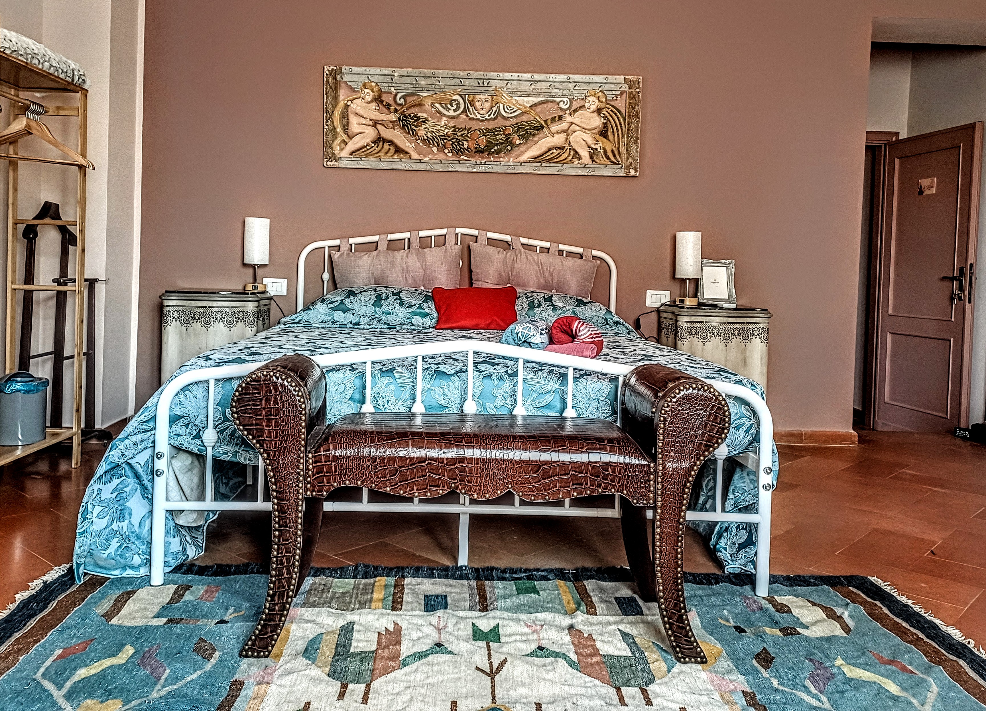 King-size bed with traditional furnishings in La Rosa Room at Genevieve Grove, Tuscany