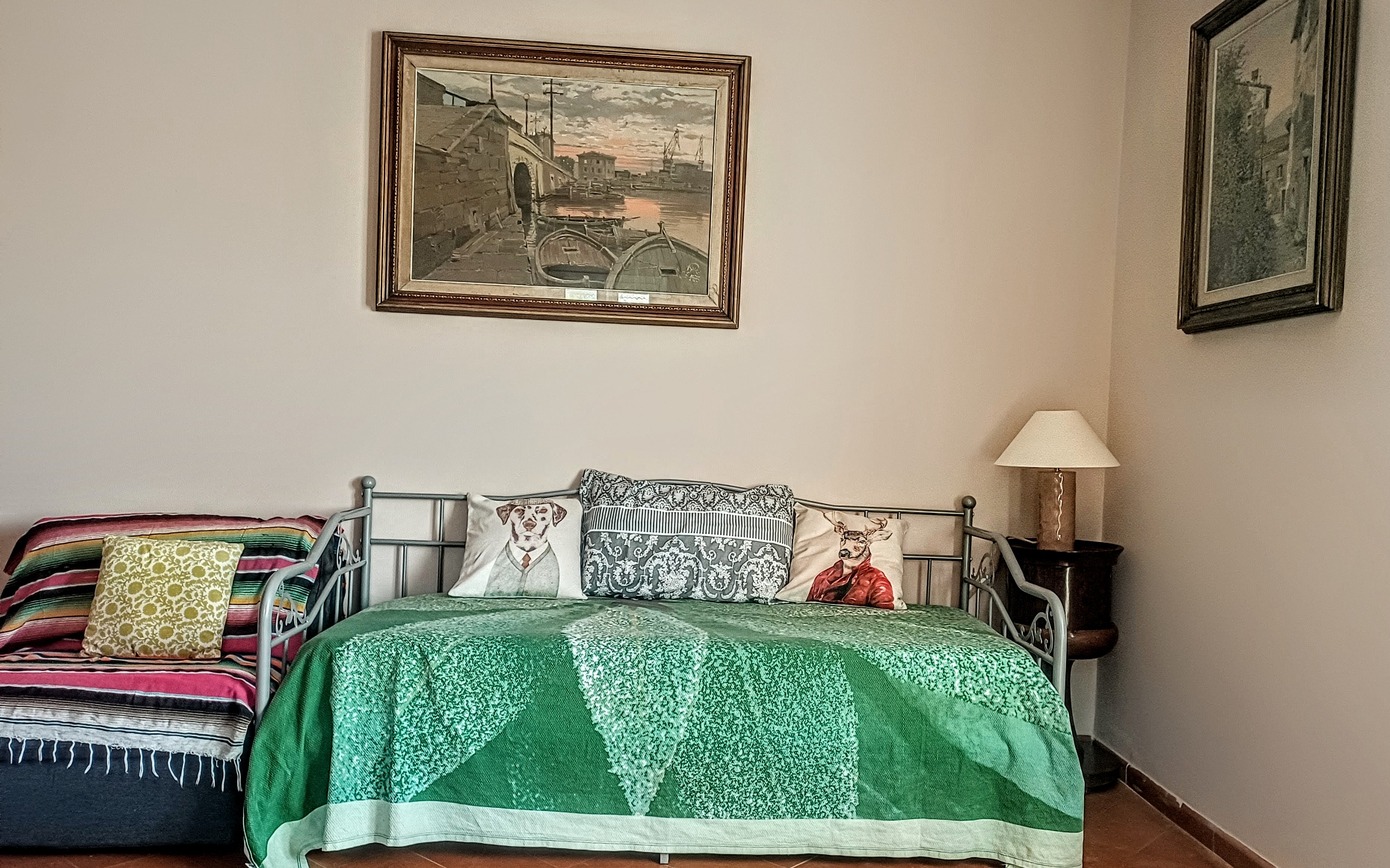 Comfortable daybed and seating area inside La Rosa Room at Genevieve Grove