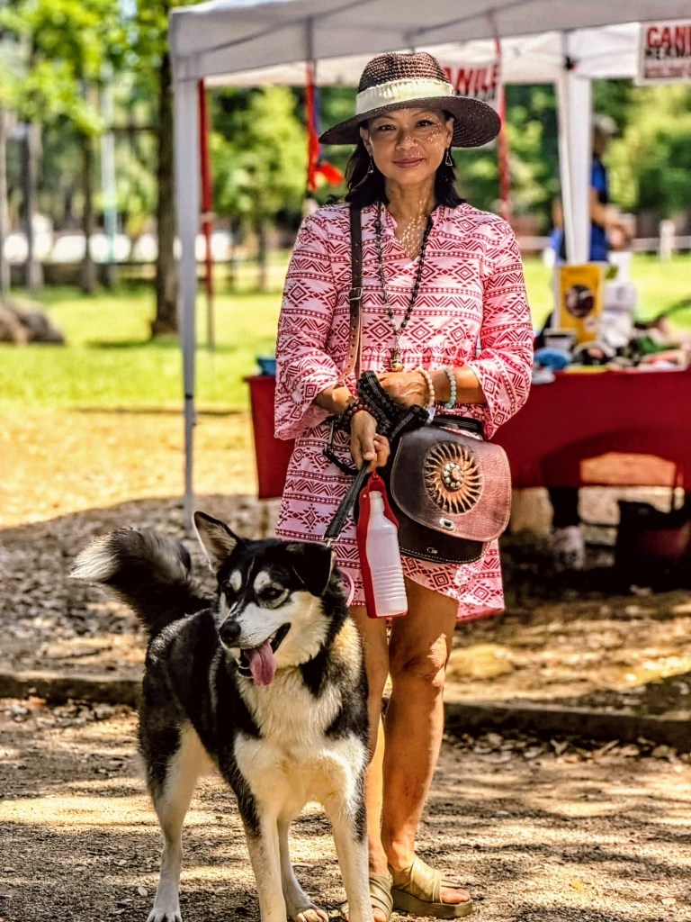 Genevieve with her dog Marilyn at an outdoor community event in Tuscany